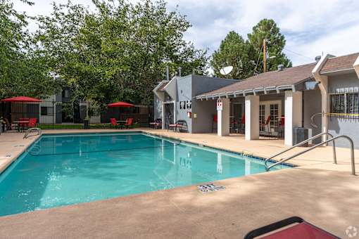 A swimming pool with a building in the background.