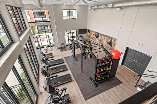A gym with treadmills, exercise bikes, and a balloon arch.