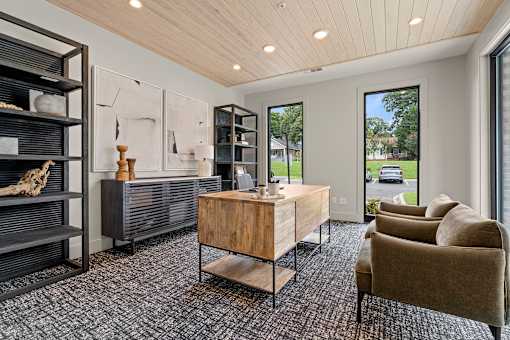 A modern living room with a wooden coffee table and a large window.