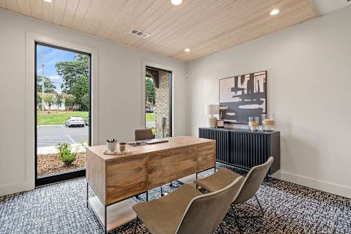 A room with a wooden desk and a chair.