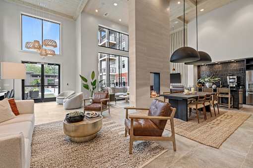 A modern living room with a large window and a fireplace.