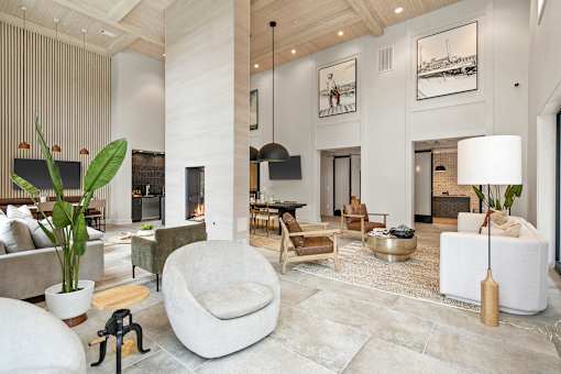 A modern living room with a large white chair in the center.