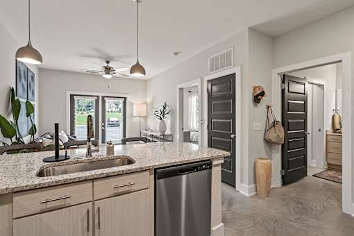 A modern kitchen with a large island and a dishwasher.