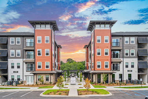 Two identical buildings are situated next to each other.