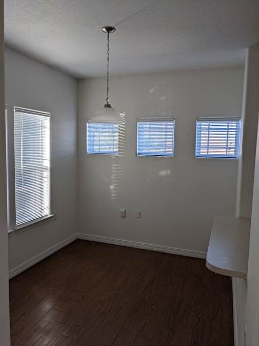 A room with wooden floors and white walls.