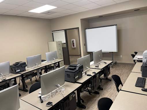A room with multiple computers and a whiteboard.