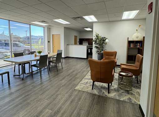 A conference room with a long table and chairs.