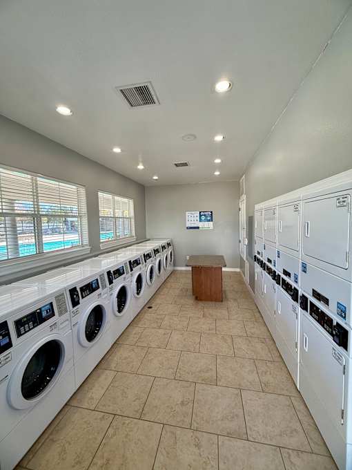 A row of washing machines in a public laundromat.