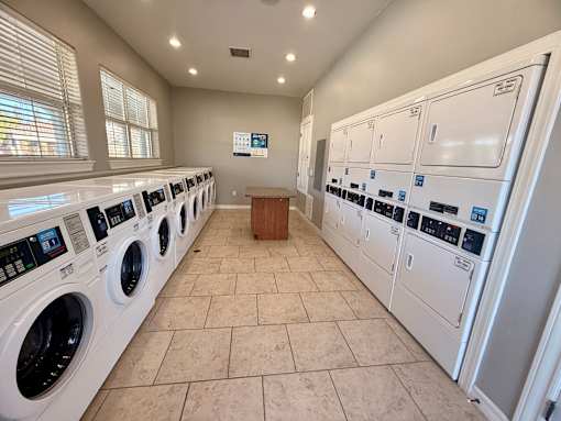A row of washing machines in a public laundromat.