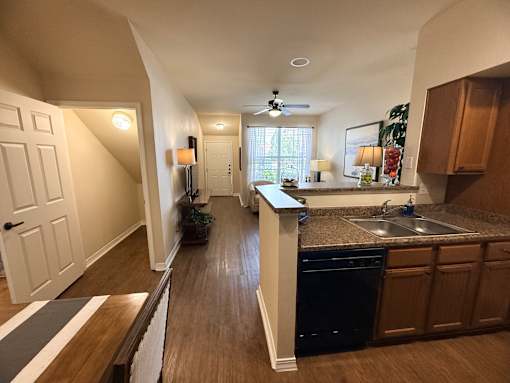 A kitchen with a sink, stove, and refrigerator.