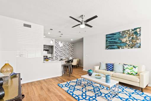 a living room with a couch and a ceiling fan