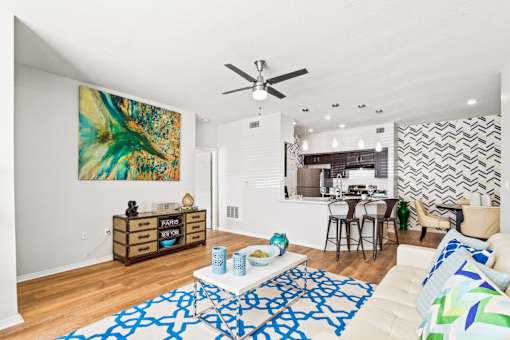 a living room with a couch and a ceiling fan