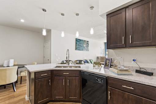a kitchen with wooden cabinets and a counter top with a sink
