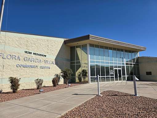 The Flora Garcia-Villa Community Center is a modern building with a large glass entrance.
