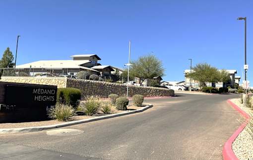 A street view of Medano Heights with a building in the background.
