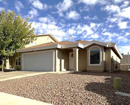 A house with a garage and a driveway.