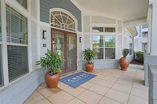 A building entrance with a blue mat on the floor.