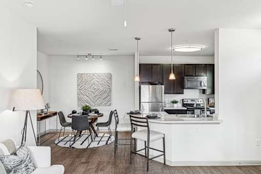 A modern kitchen with a dining table and chairs.