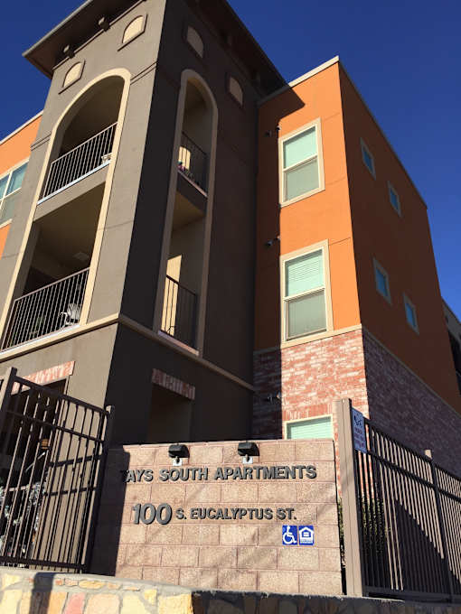 The image shows a building with a sign that reads "100 S. Eucalyptus St."