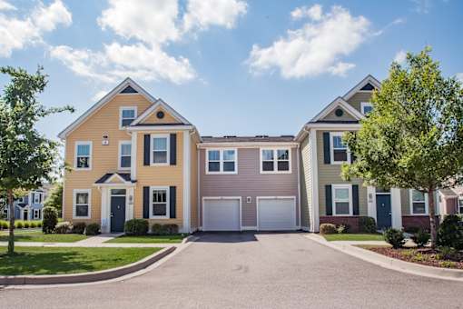 A row of houses with garages in front.