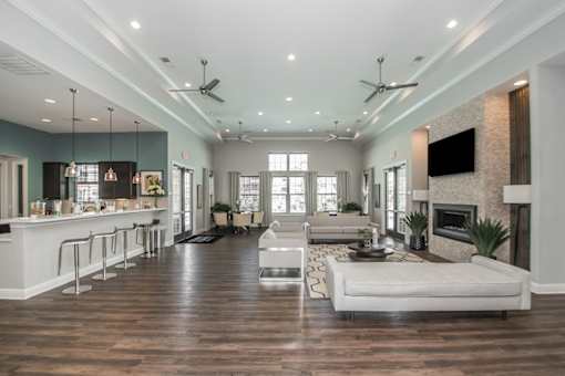 A spacious living room with a fireplace and a television.