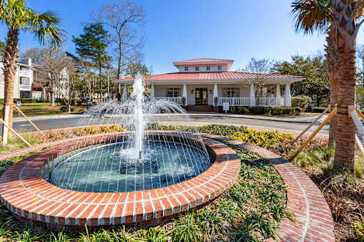 A fountain in the middle of a brick circle.