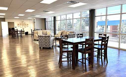 A large room with a long table and chairs.