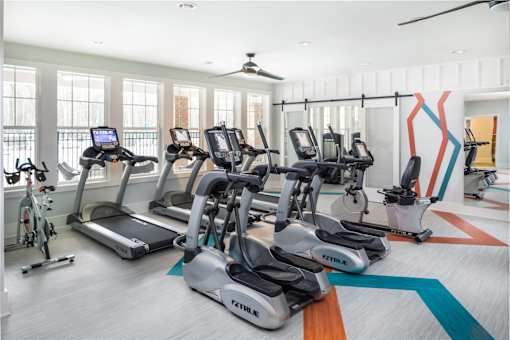 A gym with treadmills and exercise bikes.