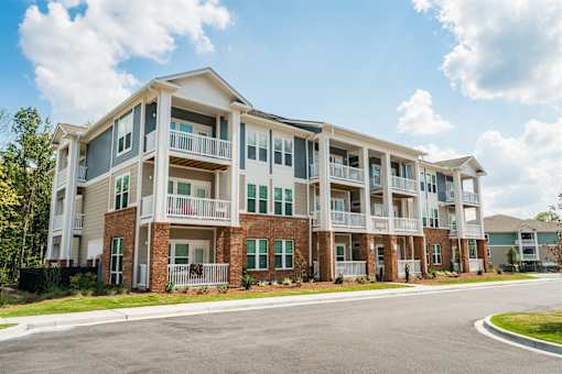 A large apartment community with multiple balconies and doors.