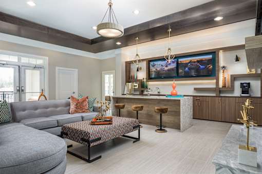 A clubroom area with entertainment and ample seating.