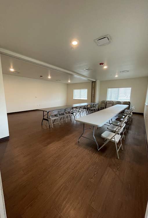 A room with a long table and chairs.