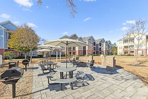 A sunny day at a courtyard with tables and chairs.