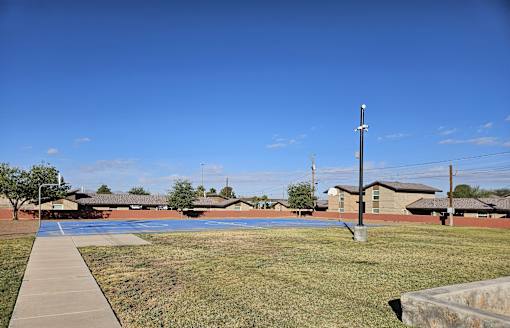 A clear blue sky over a residential area with houses and a utility pole.