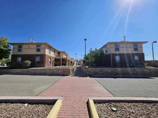A sunny day in a residential area with houses and a clear blue sky.