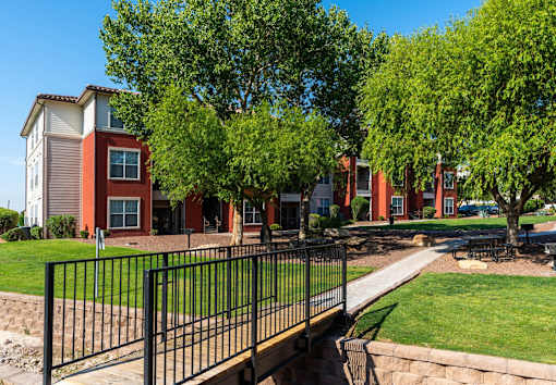 A row of houses with a black fence in front.