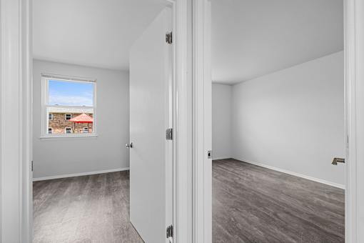 A room with a view of a building outside the window.