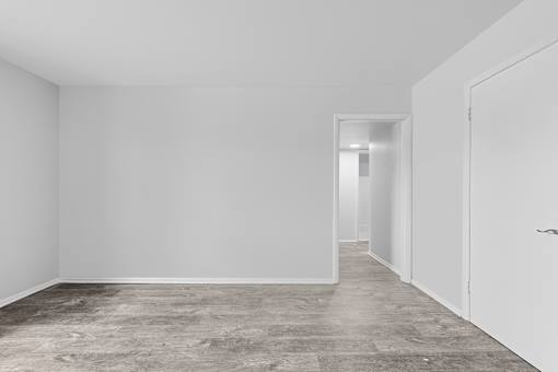 A room with a grey floor and white walls.
