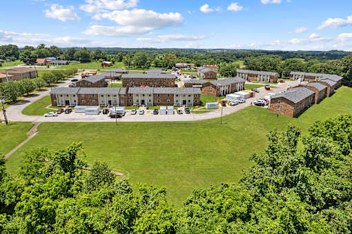 A large building complex surrounded by a green lawn.