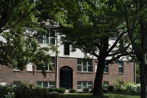 a red brick building with trees in front of it