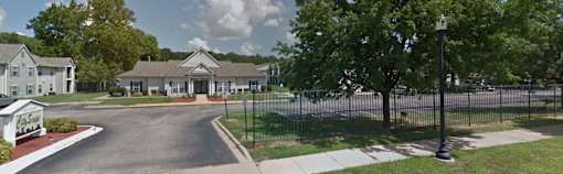 a house with a fence and a street in front of it
