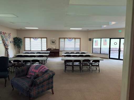 A room with tables and chairs and a couch.