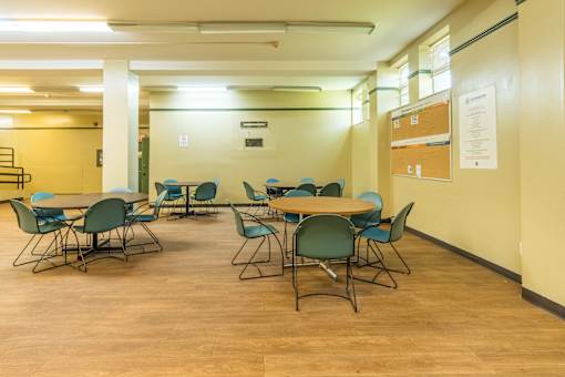 A conference room with a long table and chairs.