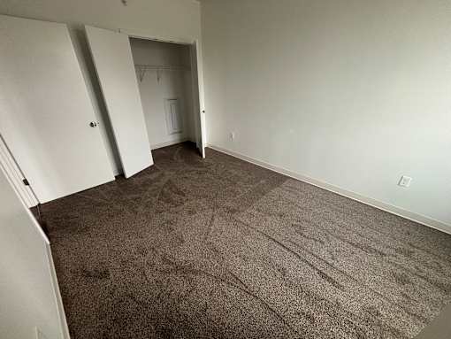 A room with carpeted floor and white walls.