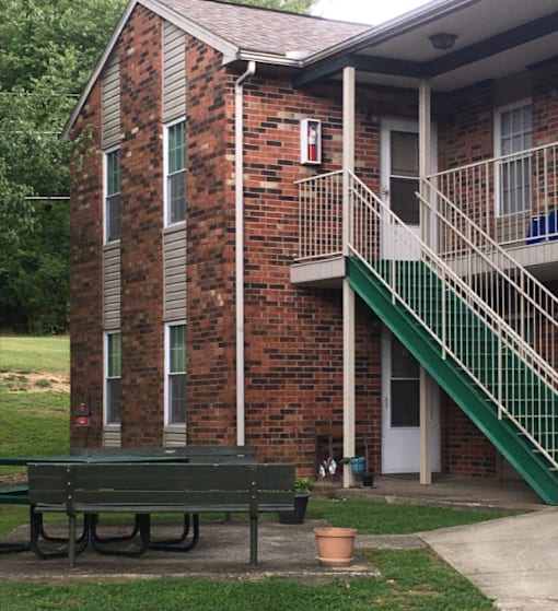 a bench in front of a building with stairs