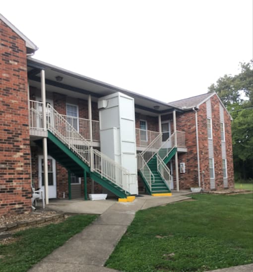 the outside of an apartment building with two sets of stairs