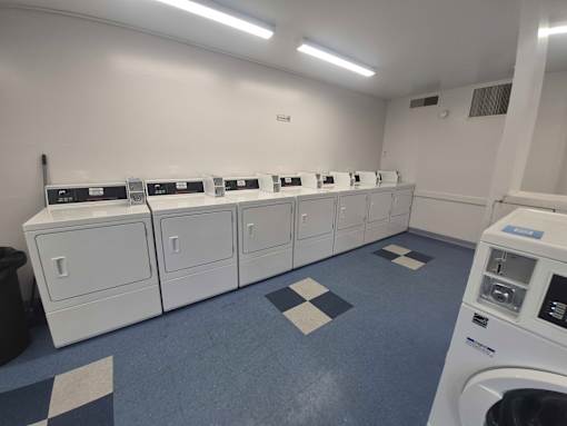 A row of washing machines in a laundromat.