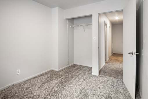 A room with a carpeted floor and white walls.