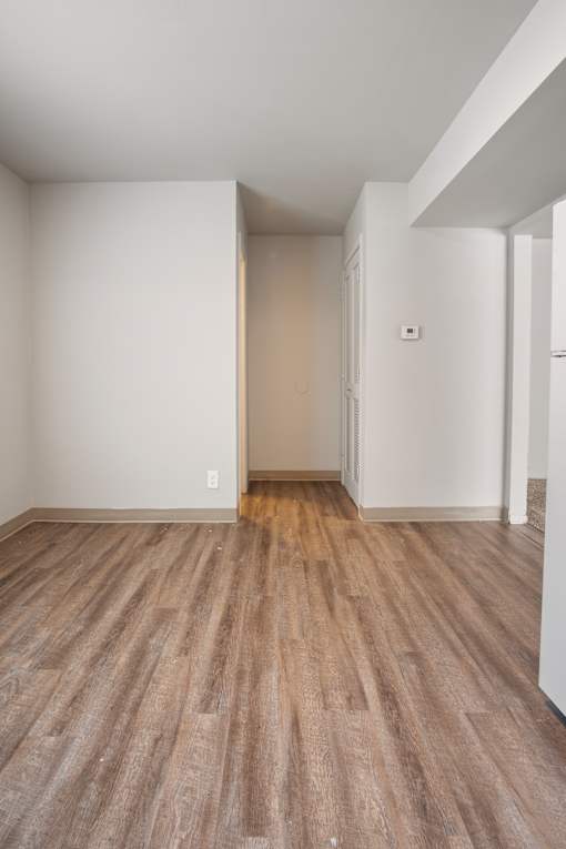 A room with a wooden floor and white walls.