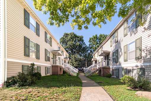 A residential area with apartment buildings and a pathway.