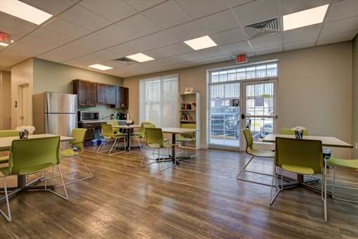 A room with a table and chairs in it.